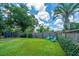This fenced backyard has a well-maintained lawn, a storage shed, and blue outdoor furniture at 160 Lancashire Rd, Summerville, SC 29486