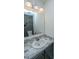 This bathroom features a single sink with a marbled countertop and a mirrored backsplash at 160 Lancashire Rd, Summerville, SC 29486