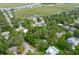 Scenic aerial shot of the home surrounded by trees, marsh, and other residences at 1604 Jungle Rd, Edisto Island, SC 29438