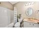 Well-lit bathroom with a shower-tub combination and a vanity with sink at 1604 Jungle Rd, Edisto Island, SC 29438