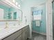 Bright bathroom with a double vanity, a separate shower, and a window at 1604 Jungle Rd, Edisto Island, SC 29438