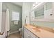 Clean, well-maintained bathroom features a vanity with a sink, a toilet and a shower with curtain at 1604 Jungle Rd, Edisto Island, SC 29438