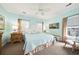 Bright bedroom featuring a queen-sized bed, ceiling fan, and natural light at 1604 Jungle Rd, Edisto Island, SC 29438