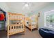 Spacious bedroom featuring wooden bunk beds, a ceiling fan, and a comfortable beanbag chair at 1604 Jungle Rd, Edisto Island, SC 29438