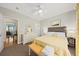 Bright bedroom featuring a queen-sized bed, ceiling fan, and a cozy sitting area at 1604 Jungle Rd, Edisto Island, SC 29438