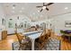 Open dining area features a large table, modern lighting, and vaulted ceiling at 1604 Jungle Rd, Edisto Island, SC 29438
