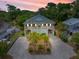Inviting two-story home with a spacious driveway, front porch, and well-kept landscaping at 1604 Jungle Rd, Edisto Island, SC 29438