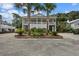 Charming two-story beach house with double porches and a well-maintained front yard at 1604 Jungle Rd, Edisto Island, SC 29438