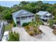 An elevated view of a beach home surrounded by lush trees and well-manicured landscaping at 1604 Jungle Rd, Edisto Island, SC 29438