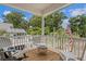 A cozy, covered front porch, perfect for enjoying quiet moments outdoors with coastal furnishings at 1604 Jungle Rd, Edisto Island, SC 29438