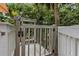 Wheelchair lift for easy access to the outdoor deck, surrounded by white railings and lush greenery at 1604 Jungle Rd, Edisto Island, SC 29438
