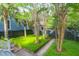 Serene backyard featuring a stone-paved pathway and beautiful palm trees at 183 Ionsborough St, Mount Pleasant, SC 29464