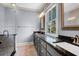 Bathroom with dual sinks, black granite countertop, and a glass shower at 183 Ionsborough St, Mount Pleasant, SC 29464