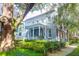 Charming home featuring a welcoming porch, American flag, and lush landscaping at 183 Ionsborough St, Mount Pleasant, SC 29464