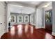 Bright living room featuring hardwood floors, multiple windows with natural light, and fireplace at 183 Ionsborough St, Mount Pleasant, SC 29464
