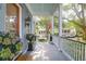 Inviting porch with classic columns, beautiful flowers and view of the neighborhood at 183 Ionsborough St, Mount Pleasant, SC 29464