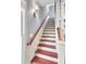 Staircase with wood treads, white risers, and a stained wood handrail at 183 Ionsborough St, Mount Pleasant, SC 29464
