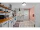 Bright kitchen with white cabinets, butcher block countertops, open shelving, and subway tile backsplash at 1940 Orangeburg St, North Charleston, SC 29405