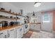 Bright kitchen with white cabinets, butcher block countertops, open shelving, and subway tile backsplash at 1940 Orangeburg St, North Charleston, SC 29405
