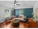 Bright living room with modern teal accents, a ceiling fan, and hardwood floors at 1940 Orangeburg St, North Charleston, SC 29405