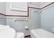 Bathroom with blue tiled walls and red accent, featuring a bathtub, toilet, and a window with white shutter-style blinds at 1967 Campion Hall Rd, Charleston, SC 29407