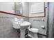 Vintage bathroom featuring a pedestal sink, tiled walls, and a window with shutter-style blinds at 1967 Campion Hall Rd, Charleston, SC 29407