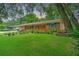 Charming single-story home with manicured lawn and garden. American flag in the front yard adds a patriotic touch at 1967 Campion Hall Rd, Charleston, SC 29407