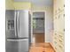 Kitchen area with stainless steel refrigerator and view into living room with sliding barn door at 1967 Campion Hall Rd, Charleston, SC 29407