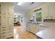 Bright kitchen with white cabinets, wood floors, stainless steel appliances, and an eat-in breakfast nook at 1967 Campion Hall Rd, Charleston, SC 29407