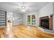 Spacious living room featuring a brick fireplace, hardwood floors, and access to the backyard at 1967 Campion Hall Rd, Charleston, SC 29407