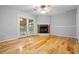 Cozy living room with hardwood floors, a red brick fireplace, and access to a screened-in porch at 1967 Campion Hall Rd, Charleston, SC 29407