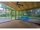 Inviting screened porch with a blue swing and view of the backyard at 1967 Campion Hall Rd, Charleston, SC 29407