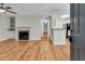 Inviting living room featuring a fireplace, hardwood floors, and open layout to the kitchen at 2011 N Hwy 17 # 2200H, Mount Pleasant, SC 29466