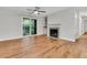 Living room with a cozy fireplace, sliding glass door to balcony, and an adjacent bar area at 2011 N Hwy 17 # 2200H, Mount Pleasant, SC 29466
