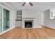 Open-concept living room with fireplace, balcony access, and view into the kitchen area at 2011 N Hwy 17 # 2200H, Mount Pleasant, SC 29466
