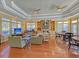Bright community lounge featuring tray ceilings, hardwood floors, ample seating, and a decorative fireplace at 2011 N Hwy 17 # 2200H, Mount Pleasant, SC 29466