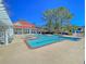 Community pool featuring a spacious deck, surrounded by trees and blue skies at 2011 N Hwy 17 # 2200H, Mount Pleasant, SC 29466