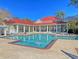 Inviting pool area with a large pool, comfortable lounge chairs, and a clubhouse with a red roof at 2011 N Hwy 17 # 2200H, Mount Pleasant, SC 29466