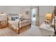 Well-lit bedroom featuring a decorative iron bed frame, neutral walls, and soft natural light at 2038 Sea Water Dr, James Island, SC 29412