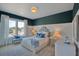 This well-lit bedroom offers a combination of dark walls with white trim and blue accents at 2038 Sea Water Dr, James Island, SC 29412