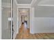 View of the long hallway with hardwood floors, molding and neutral walls at 2038 Sea Water Dr, James Island, SC 29412