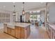 Open kitchen featuring a large island with seating, stainless steel appliances, and hardwood floors at 2038 Sea Water Dr, James Island, SC 29412