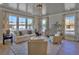 Bright living room featuring a decorative ceiling, large windows, and neutral furniture at 2038 Sea Water Dr, James Island, SC 29412