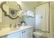 Well lit bathroom has a marble vanity and a shower with a curtain at 204 Michigan Ave # C-5 - 11, Folly Beach, SC 29439