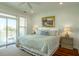 This bedroom boasts a balcony, a plush bed, and refined decor at 204 Michigan Ave # C-5 - 11, Folly Beach, SC 29439