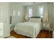Comfortable bedroom features a full bed, bedside tables, and window with curtains at 204 Michigan Ave # C-5 - 11, Folly Beach, SC 29439