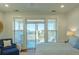 Bright bedroom with sliding glass doors leading to a sun-soaked deck and scenic views at 204 Michigan Ave # C-5 - 11, Folly Beach, SC 29439