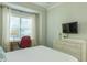 Bright bedroom has a writing desk by the window and white furnishings at 204 Michigan Ave # C-5 - 11, Folly Beach, SC 29439
