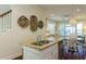Open kitchen with stainless steel appliances, granite countertops, and views of the living area at 204 Michigan Ave # C-5 - 11, Folly Beach, SC 29439