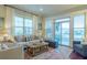 Bright and airy living room featuring stylish furniture, large windows, and access to an outdoor space at 204 Michigan Ave # C-5 - 11, Folly Beach, SC 29439